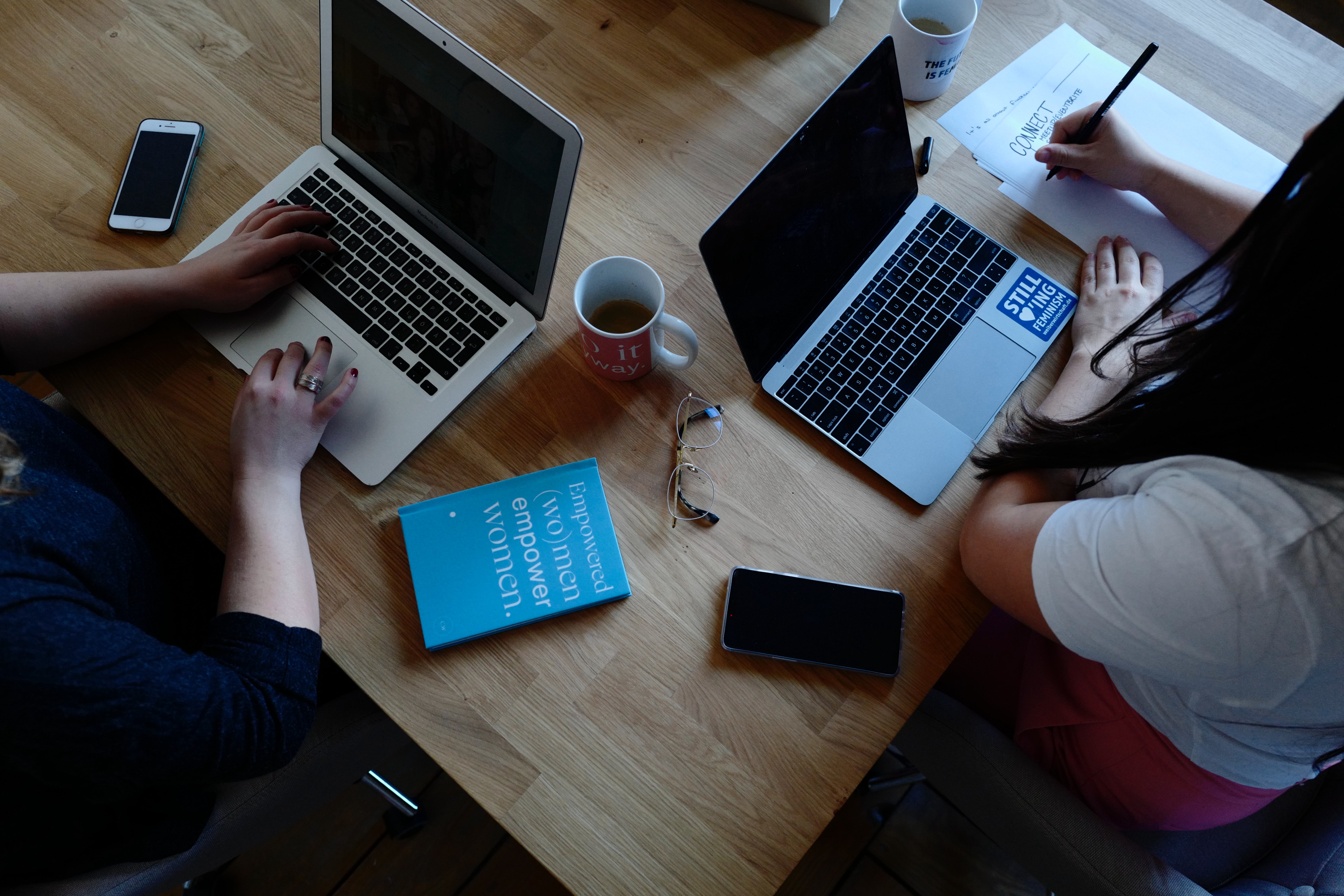 two-women-at-laptops-working-together